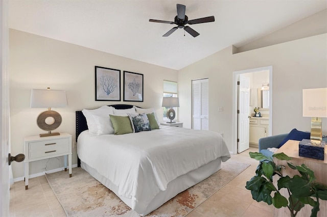 tiled bedroom with ceiling fan, lofted ceiling, a closet, and ensuite bath