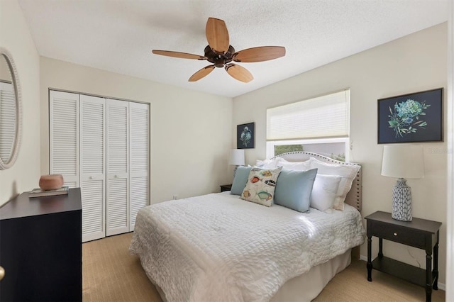 bedroom featuring light carpet, a closet, and ceiling fan