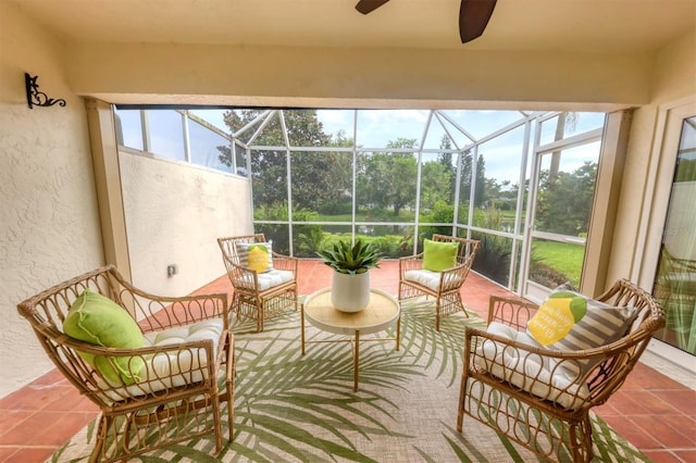 sunroom / solarium featuring ceiling fan