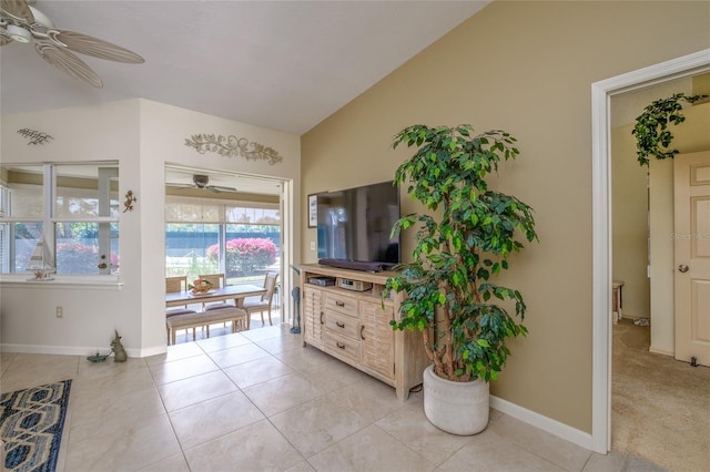 entryway featuring ceiling fan, light tile floors, and vaulted ceiling