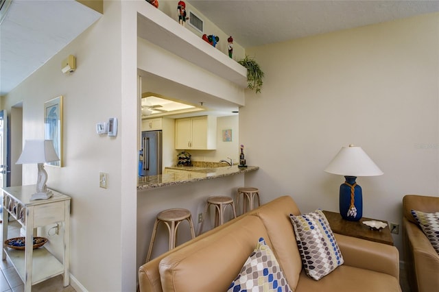 living room with light tile flooring and ceiling fan