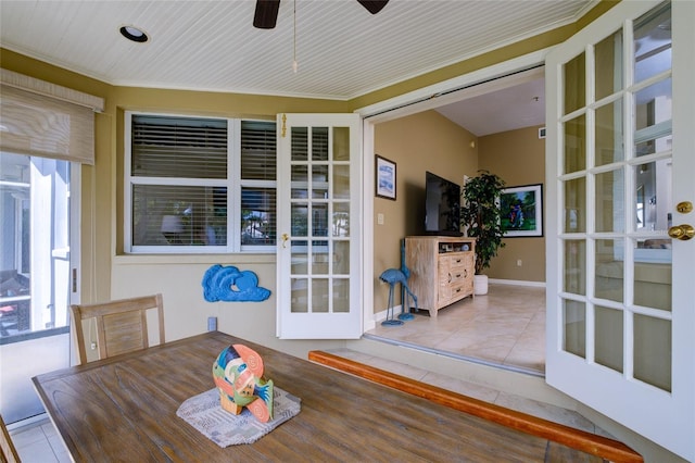 tiled dining room with french doors and ceiling fan