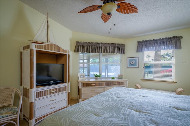 bedroom with a textured ceiling and ceiling fan