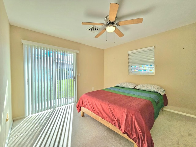 bedroom with access to exterior, light carpet, multiple windows, and ceiling fan