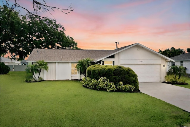 single story home with a lawn and a garage