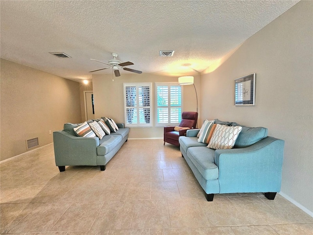 tiled living room featuring ceiling fan and a textured ceiling