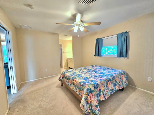 carpeted bedroom with connected bathroom and ceiling fan