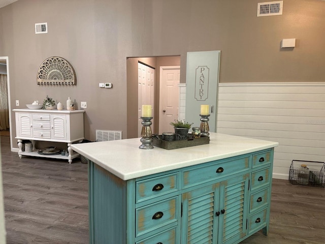 kitchen with a center island and dark wood-type flooring