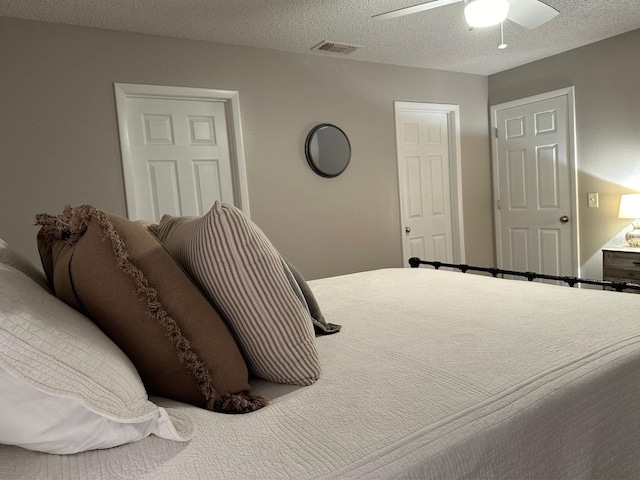 bedroom with a textured ceiling and ceiling fan