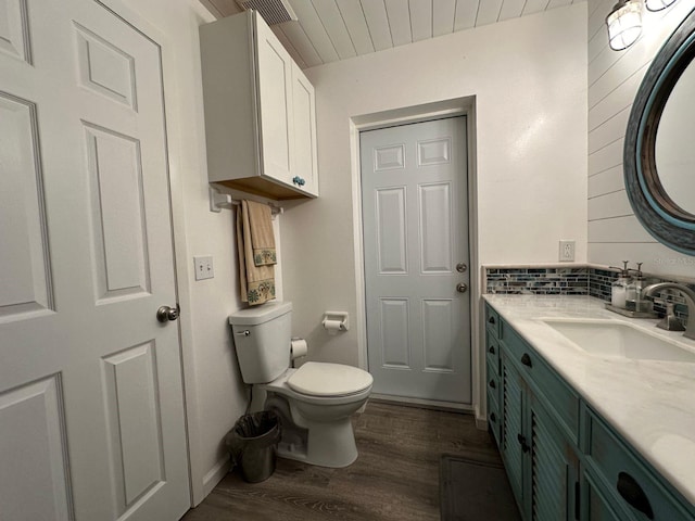 bathroom featuring vanity, hardwood / wood-style floors, and toilet