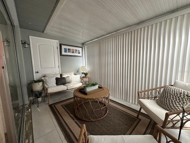 interior space with light tile floors and vaulted ceiling