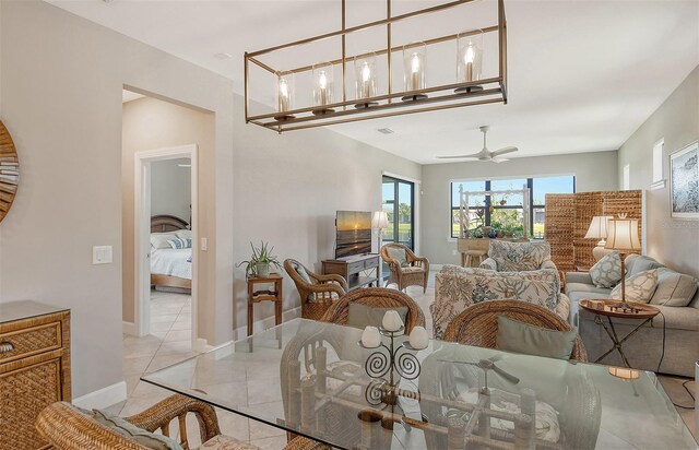 dining space with light tile flooring and ceiling fan