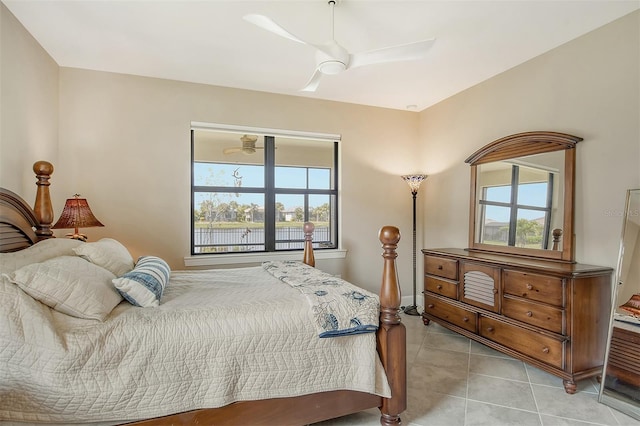 tiled bedroom featuring multiple windows and ceiling fan