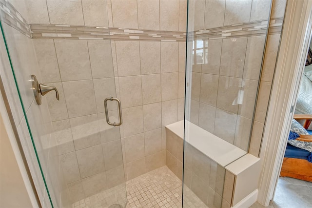 bathroom featuring a shower with door