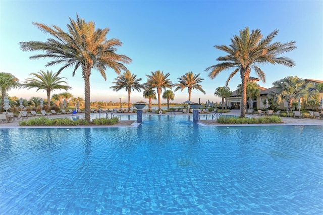 view of pool at dusk