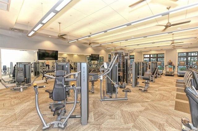 gym featuring light carpet and ceiling fan