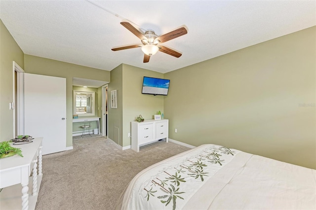 bedroom with light carpet, a textured ceiling, and ceiling fan