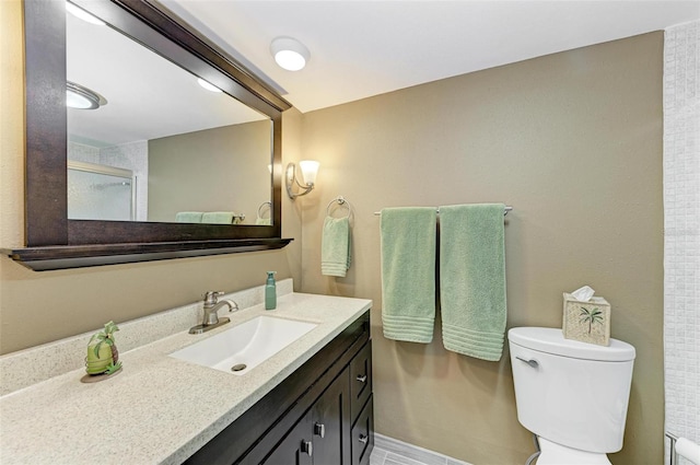 bathroom featuring oversized vanity and toilet