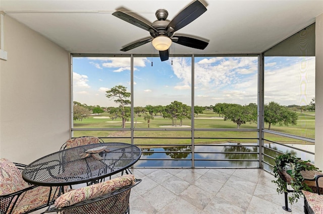 sunroom with a healthy amount of sunlight and ceiling fan