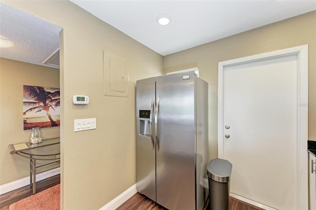 kitchen with stainless steel fridge with ice dispenser, a textured ceiling, and dark hardwood / wood-style floors