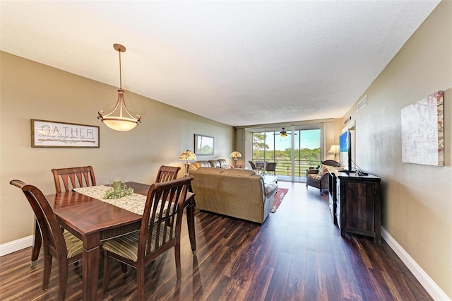 dining space with a textured ceiling, ceiling fan, and dark hardwood / wood-style flooring