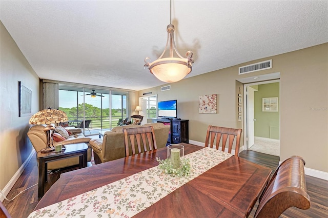 dining room featuring a textured ceiling, ceiling fan, and dark hardwood / wood-style flooring