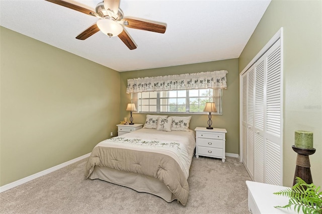 bedroom with a closet, light carpet, and ceiling fan