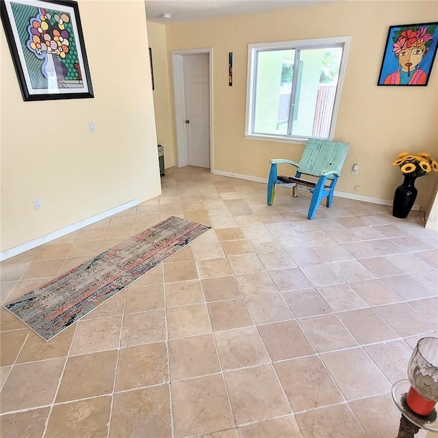 unfurnished room featuring light tile floors