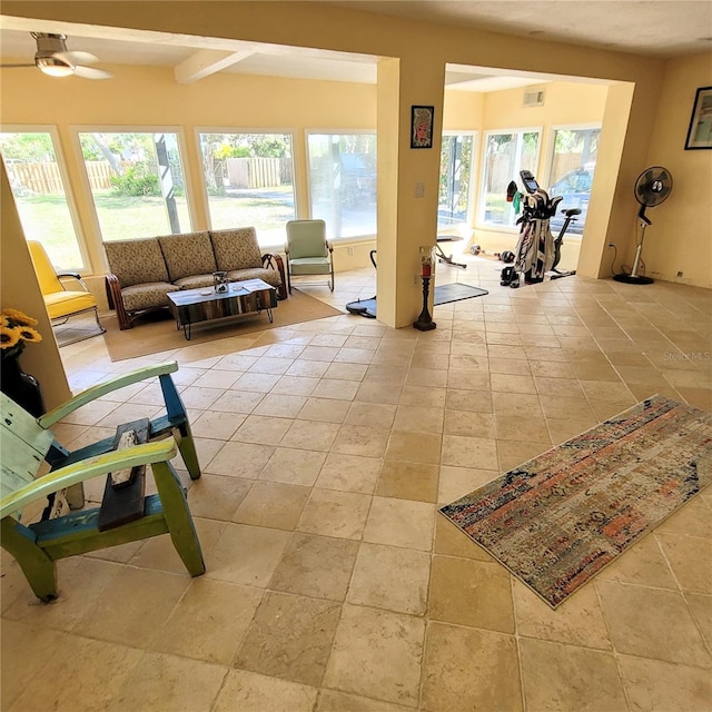 tiled living room with plenty of natural light, ceiling fan, and beamed ceiling