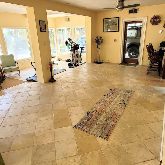 interior space featuring ceiling fan and light tile flooring