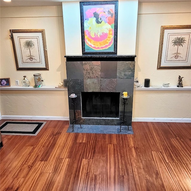 living room with dark wood-type flooring and a fireplace