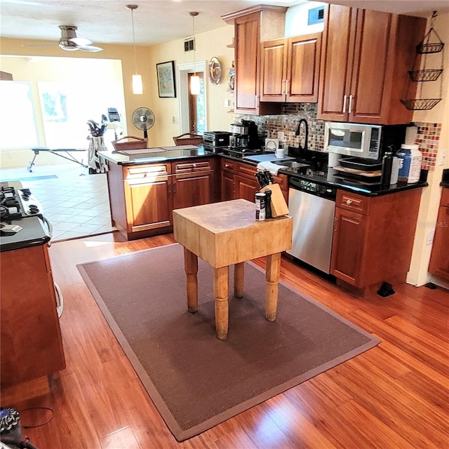 kitchen with plenty of natural light, appliances with stainless steel finishes, and light wood-type flooring