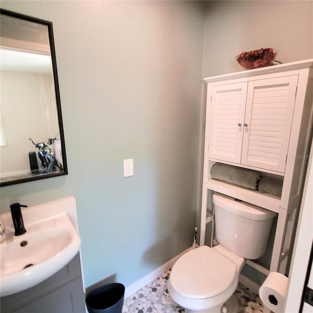 bathroom featuring toilet, tile flooring, and vanity