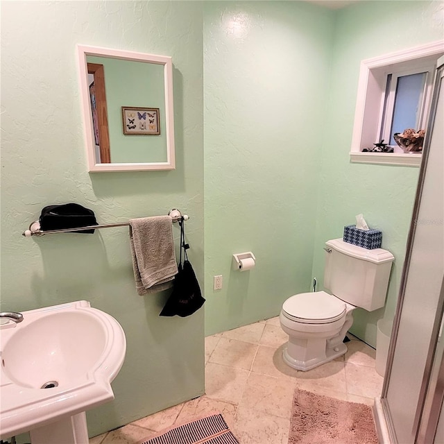 bathroom with sink, tile floors, and toilet