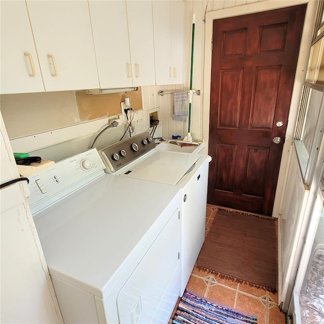 washroom featuring washer and dryer, light tile flooring, cabinets, and sink