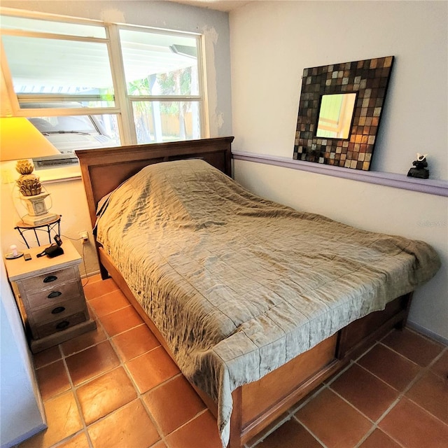 bedroom featuring dark tile flooring