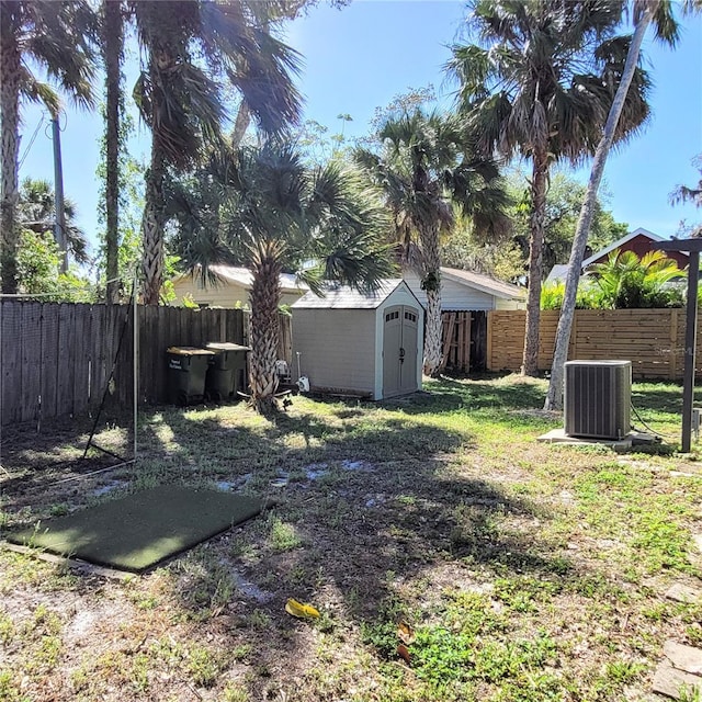 view of yard featuring a shed and central AC unit