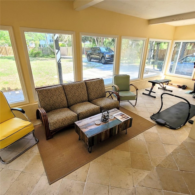 sunroom featuring beamed ceiling