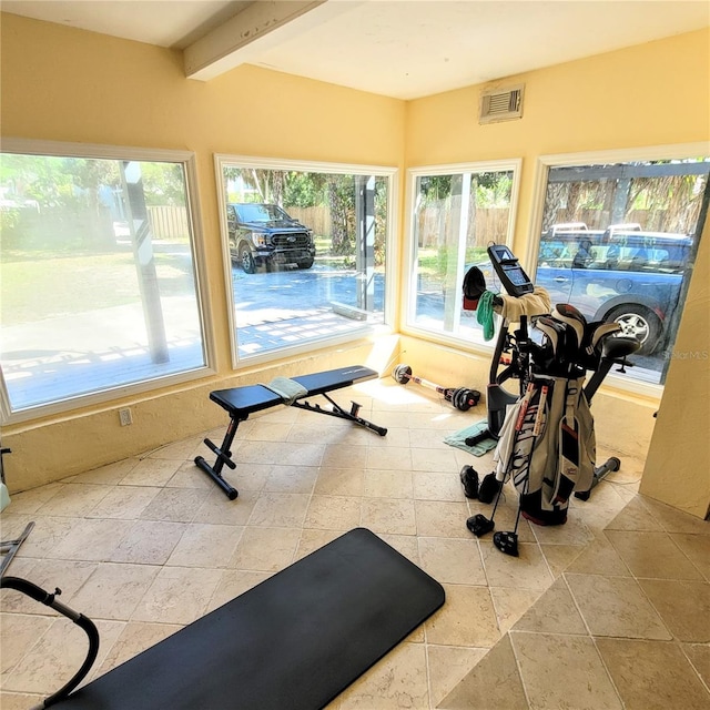 exercise room featuring light tile floors