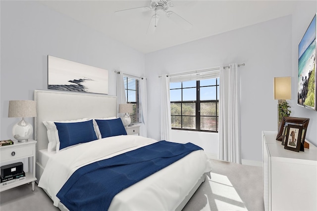 bedroom featuring light colored carpet and ceiling fan