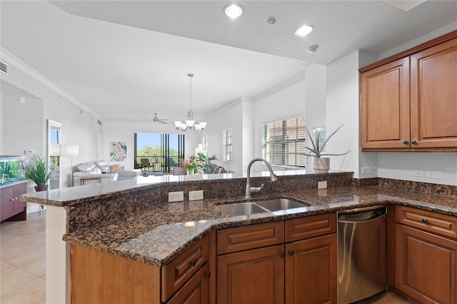 kitchen with dishwasher, sink, dark stone counters, and decorative light fixtures