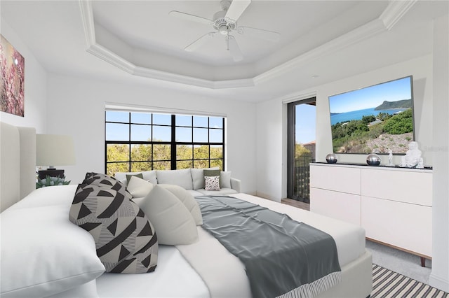 bedroom with crown molding, a tray ceiling, light colored carpet, and ceiling fan