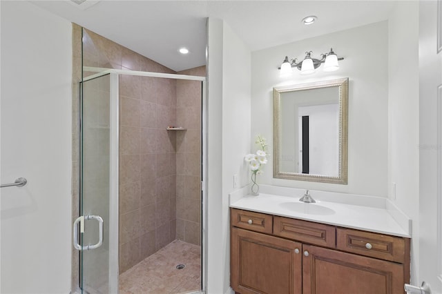 bathroom with a shower with door and vanity