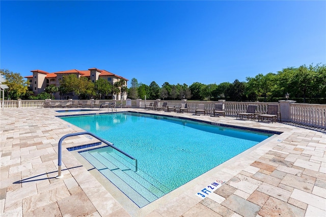 view of swimming pool featuring a patio area