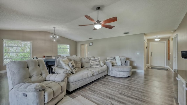 living room with light hardwood / wood-style flooring, ceiling fan, a textured ceiling, and lofted ceiling