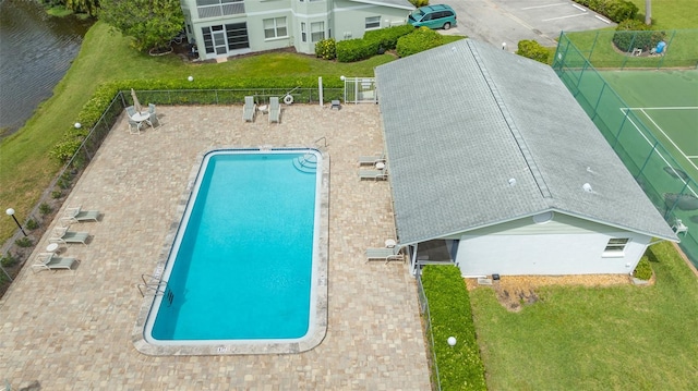 view of pool with a lawn