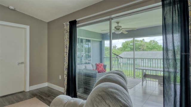 interior space featuring ceiling fan and tile floors