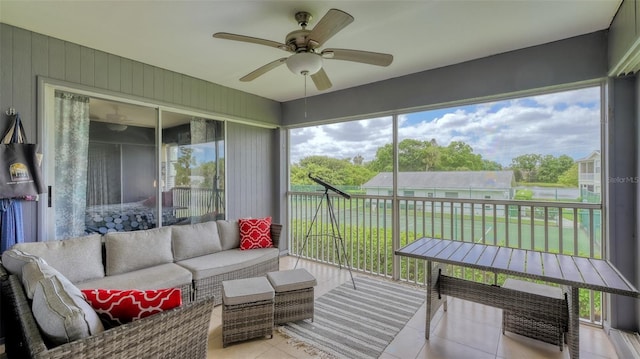 sunroom featuring a healthy amount of sunlight and ceiling fan