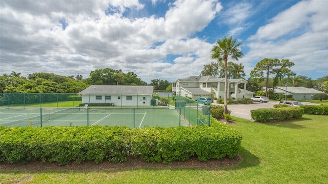 view of tennis court with a lawn