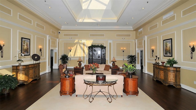 interior space with a skylight, dark hardwood / wood-style floors, a towering ceiling, and a tray ceiling